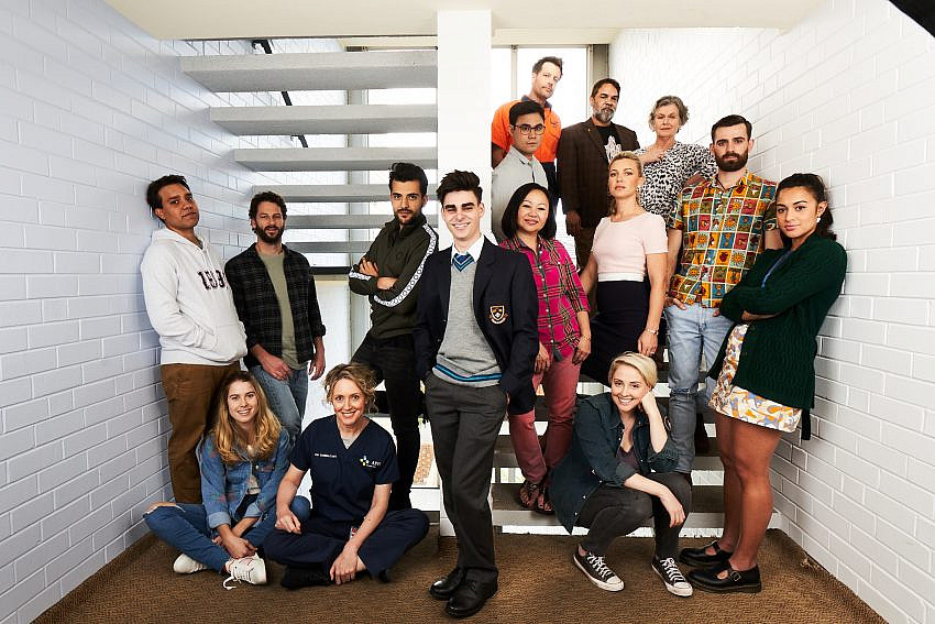 Photo of the cast of The Heights Season 2 posing in a stairwell