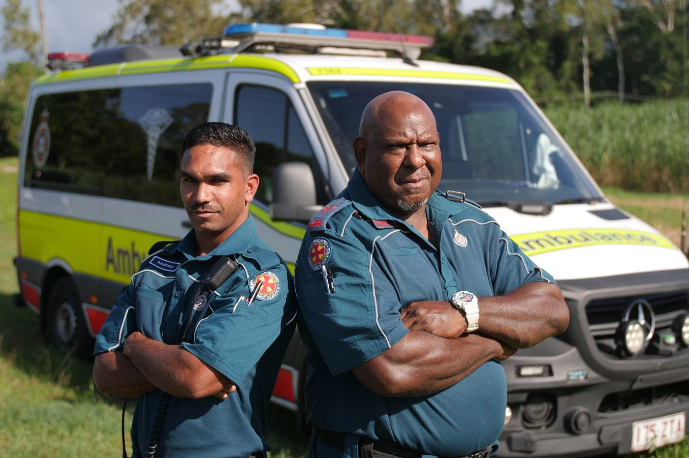 Andrew Garrett and George Fennemore who work as paramedics in front of an ambulance.