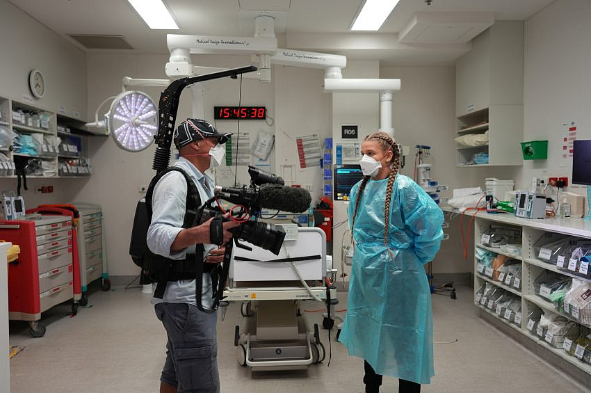 Assoc. Professor Kris Rallah Baker with film crew inside a hosptial.